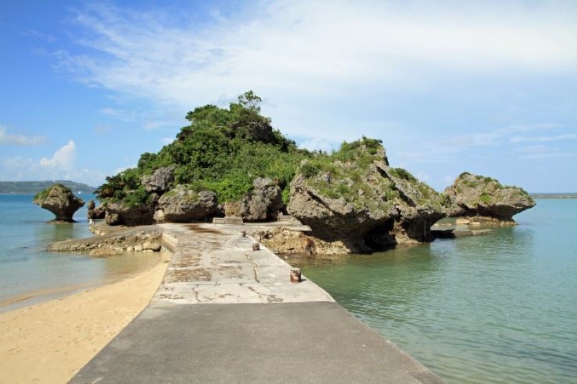 青い海を背景に、美しいシルエットが特徴の「アマンジ」と呼ばれる小さな島に、アマミチューの墓があります